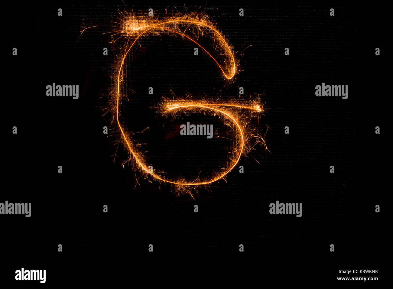 Letter G made of sparklers on black Stock Photo