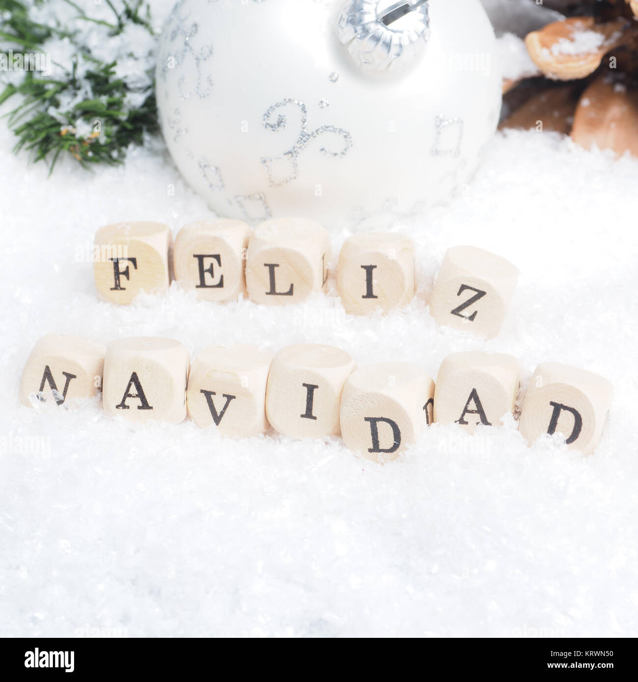 Christmas background with the Spanish words Feliz Navidad of Merry Christmas in snow Stock Photo