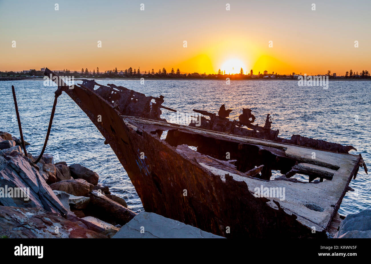 Australia, New South Wales, Newcastle Harbour, Stockton breakwall, sunset against the wreck of the french four-masted bark Adolphe, which was wrecked  Stock Photo