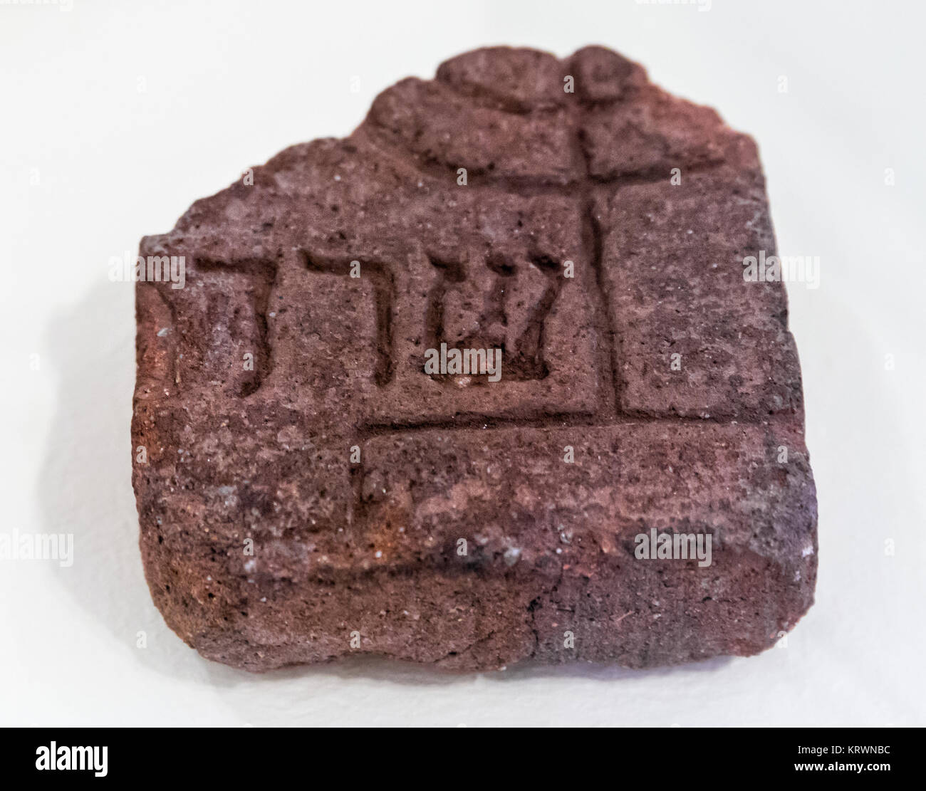 Old brick, for funerary use, with seven-branched candelabrum and Sarah in Hebrew letters. Middle Ages. Stock Photo