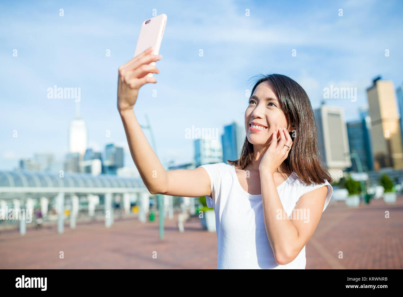 Woman taking selfie by mobile phone in Hong Kong Stock Photo - Alamy