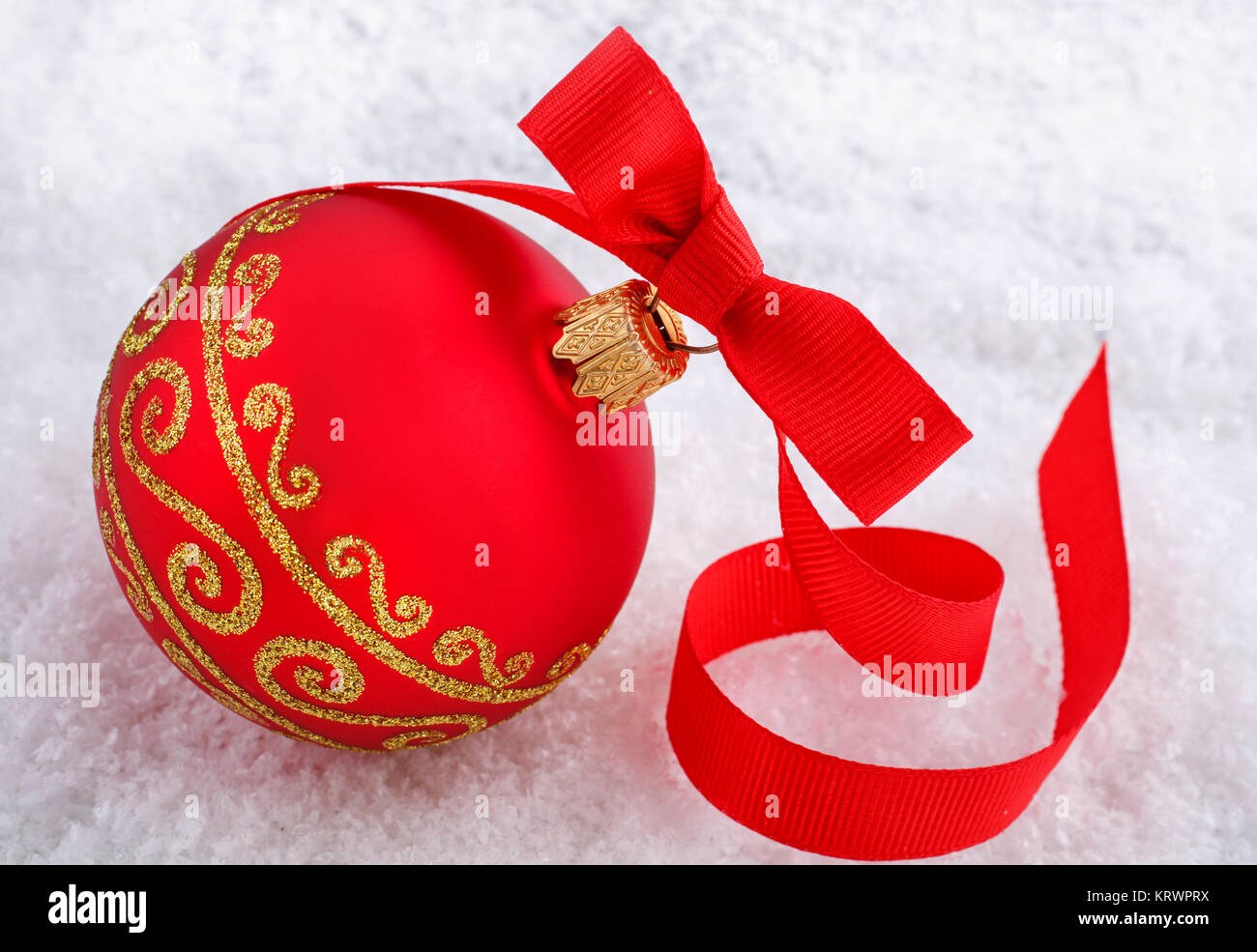 Red Christmas ball with ornament on snow Stock Photo - Alamy
