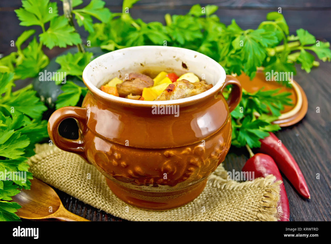 Roast meat and potatoes in pot on dark board Stock Photo Alamy