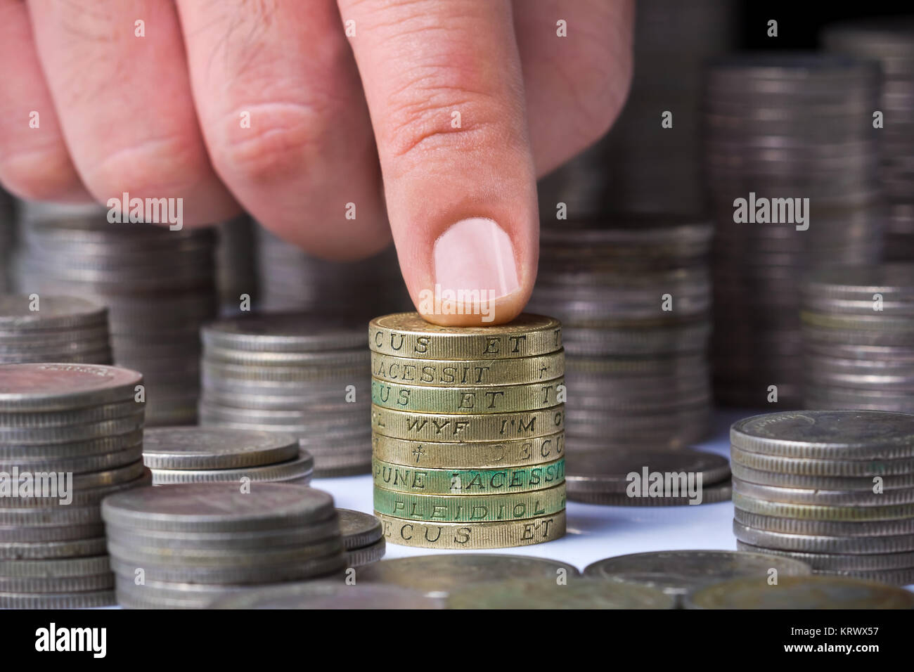 Pounds Stack Closeup of stack of british pound coins with a male hand Stock Photo ...