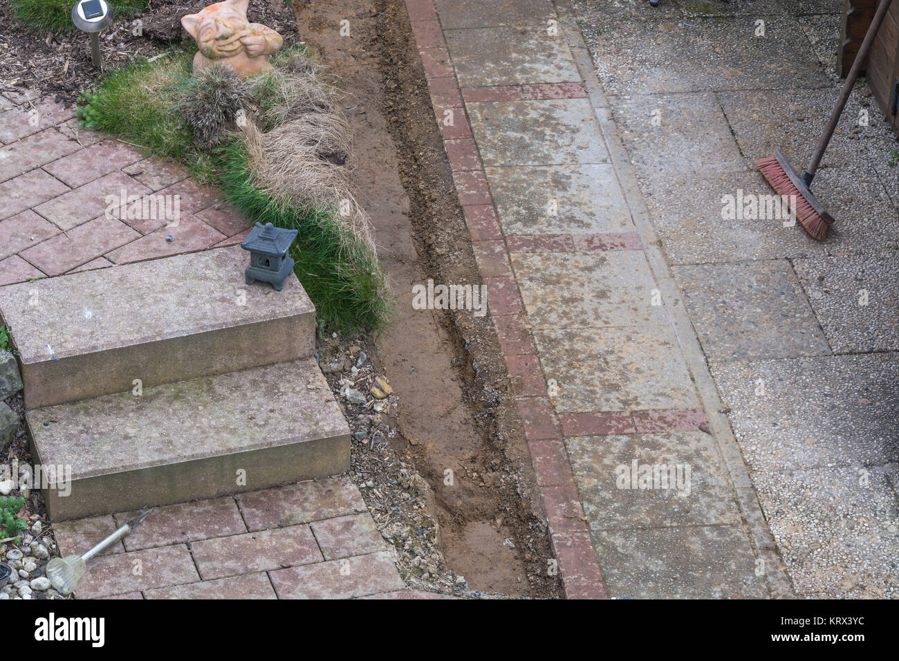 sweeping and cleaning the garden paths. Stock Photo