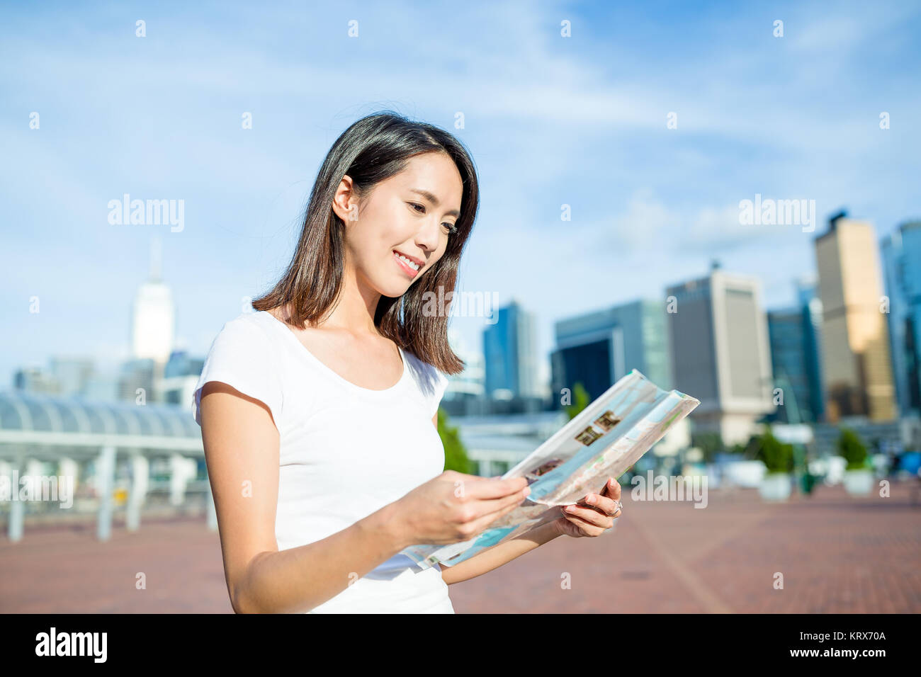 Woman visiting Hong Kong with paper map Stock Photo - Alamy