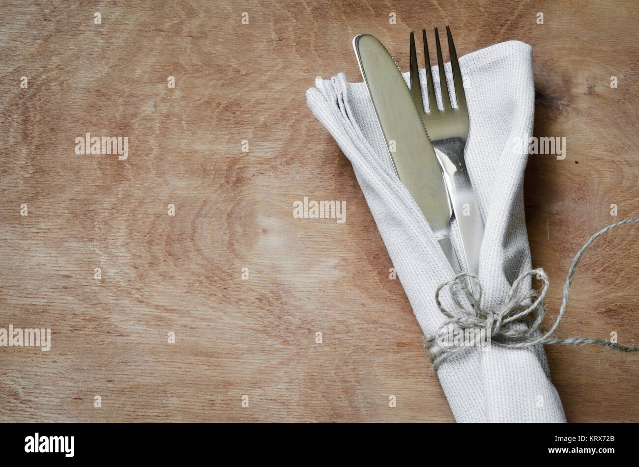 Fork and Knife Tied on White Napkin on Wooden Table. Table Setting ...
