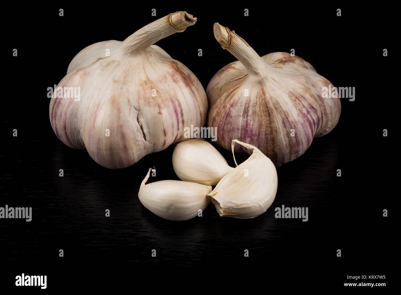 Garlic bulb on dark background Stock Photo - Alamy