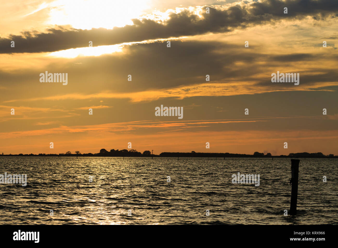 Sunset over water Stock Photo - Alamy