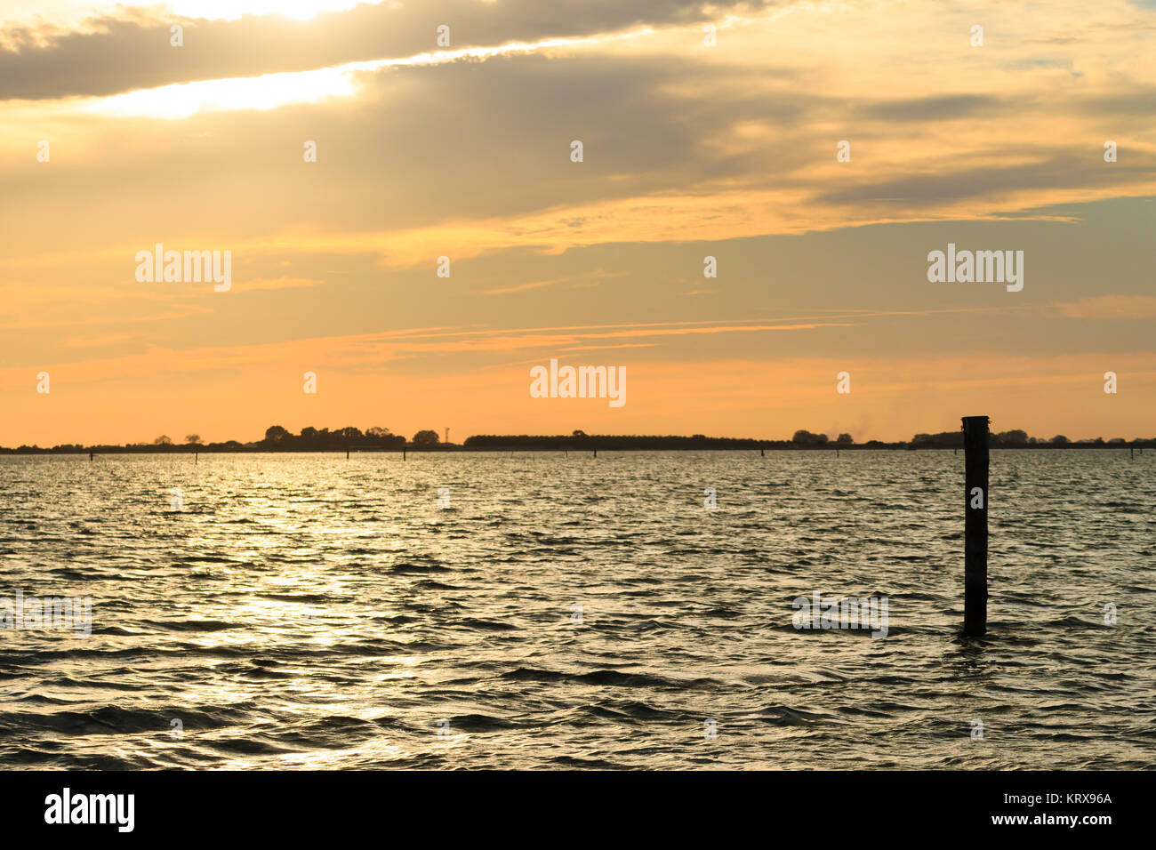 Sunset over water Stock Photo - Alamy