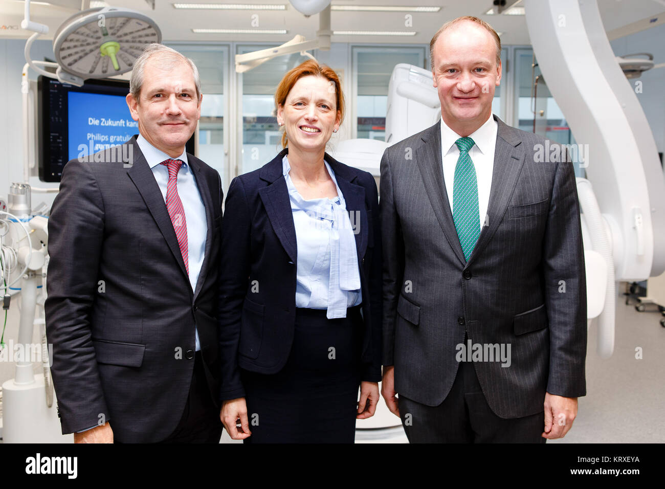 Schleswig-Holstein's Minsiter of Science and Education Karin Prien (CDU, c), the Chairman of the University Clinic Schleswig-Holstein (UKSH) Prof. Dr. Jens Scholz (l) and Peter Vullinghs of the company Philips stand in a hybrid operation room on the occasion of the inauguration of six highly modern operating rooms at the University Clinic Schleswig-Holstein ('Universitaetsklinikum Schleswig-Holstein', UKSH) in Kiel, Germany, 21 December 2017. The operation rooms are equipped with the 'da Vinci' surgery system and a new navigation technology for spine operations, inter alia. Photo: Frank Molter Stock Photo