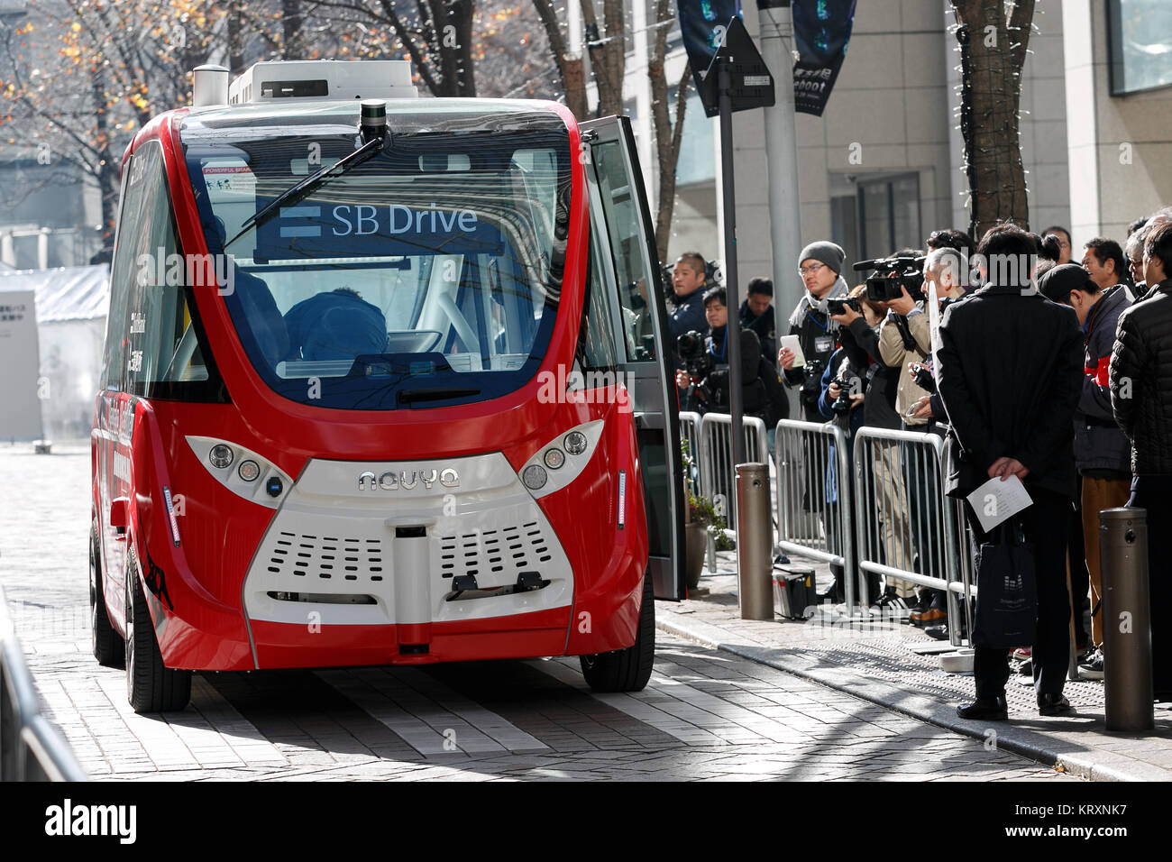 Tokyo, Japan. 22nd Dec, 2017. A self-driving electric shuttle bus Navya Arma is introduced at a press event on December 22, 2017, Tokyo, Japan. The driverless French electric vehicle (EV) developed by Navya Technologies SAS can carry up to 15 passengers and reach 45kmh. Japan's telecom giant SoftBank's subsidiary SB Drive and Mitsubishi Estate Co., Ltd. collaborated on the vehicle, and Japanese government is aiming to promote the autonomous driving technology ahead of the Tokyo 2020 Olympics. Credit: Rodrigo Reyes Marin/AFLO/Alamy Live News Stock Photo