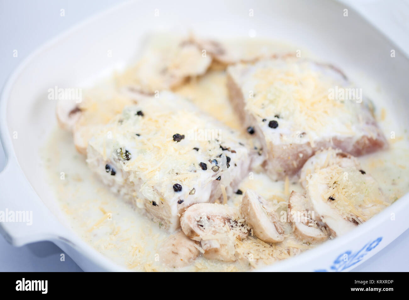 Fish fillet preparation Marinated raw sea bass fillet with mushrooms in a baking dish Stock