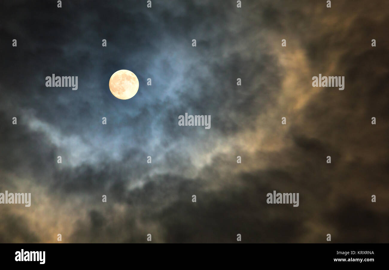 Mysterious midnight cloudy sky with full moon and moonlit clouds Stock Photo