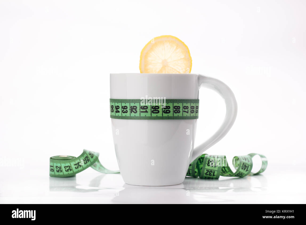 measure and lemon in white cup Stock Photo