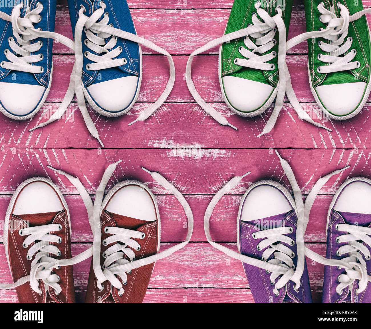 Youth colored sneakers on old pink wooden surface, top view Stock Photo ...