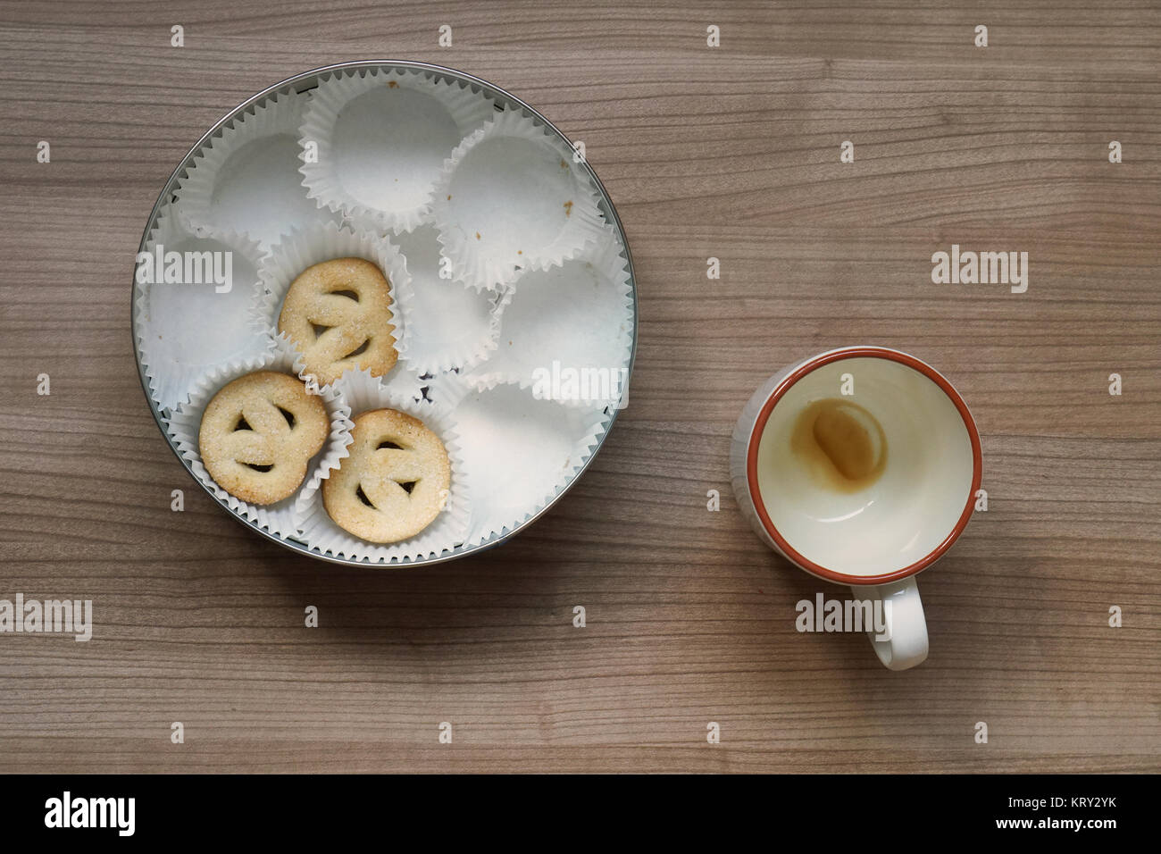 empty coffee cup and cookie tin Stock Photo Alamy