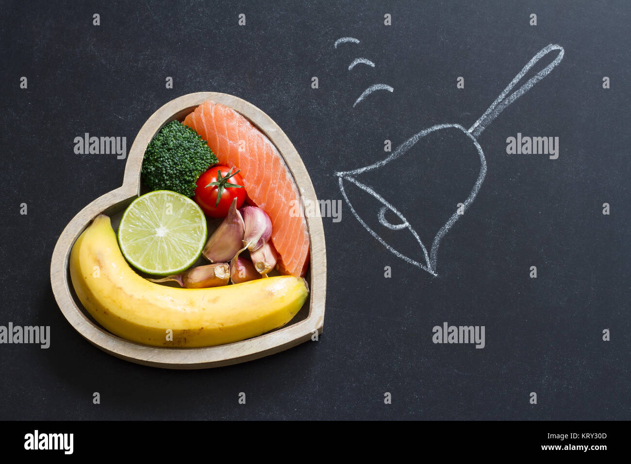 Time for health heart abstract diet food concept on blackboard with bell Stock Photo