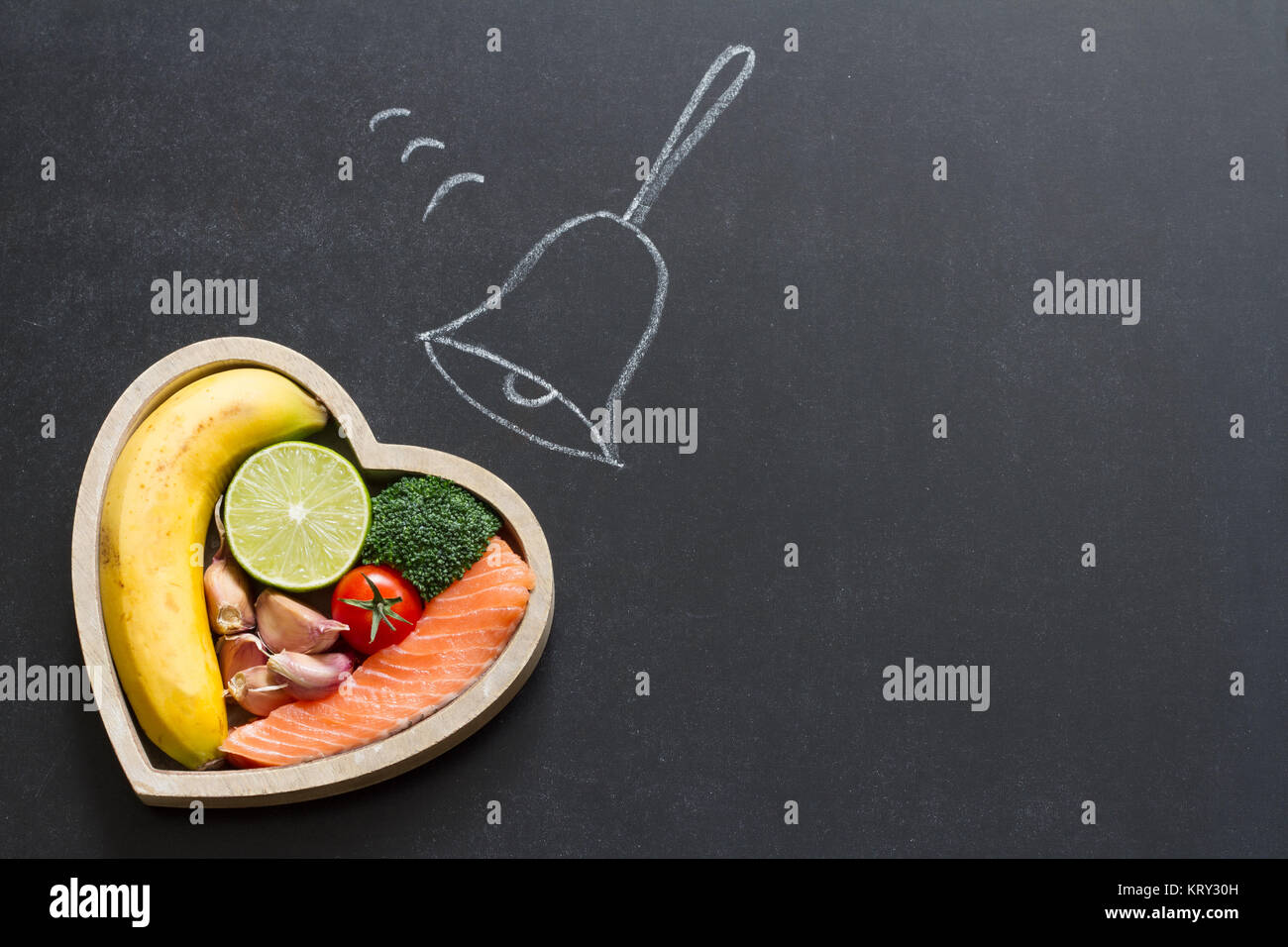 Time for health heart abstract diet food concept on blackboard with bell Stock Photo