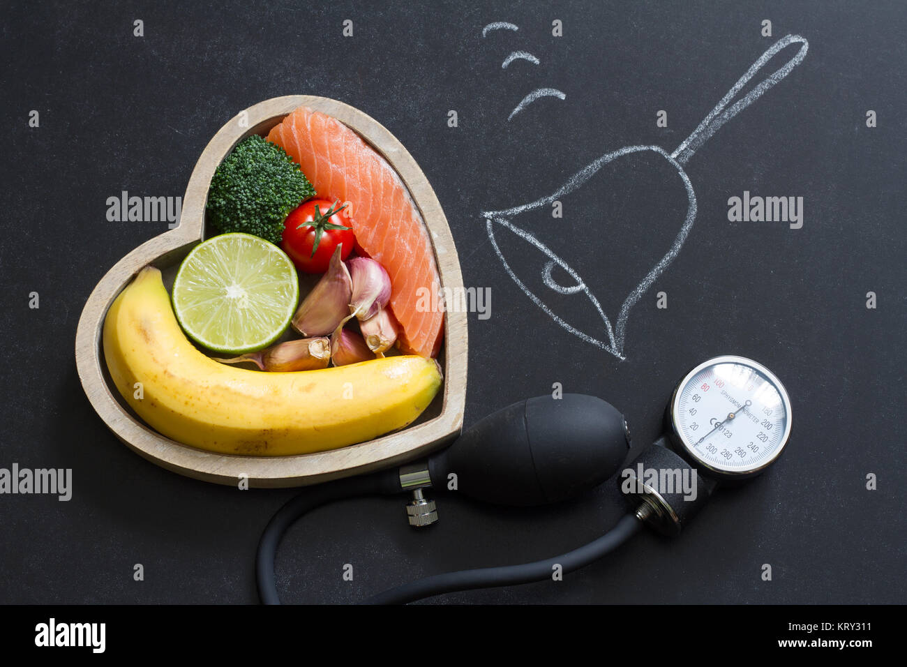 Time for health heart abstract diet food concept on blackboard with bell Stock Photo