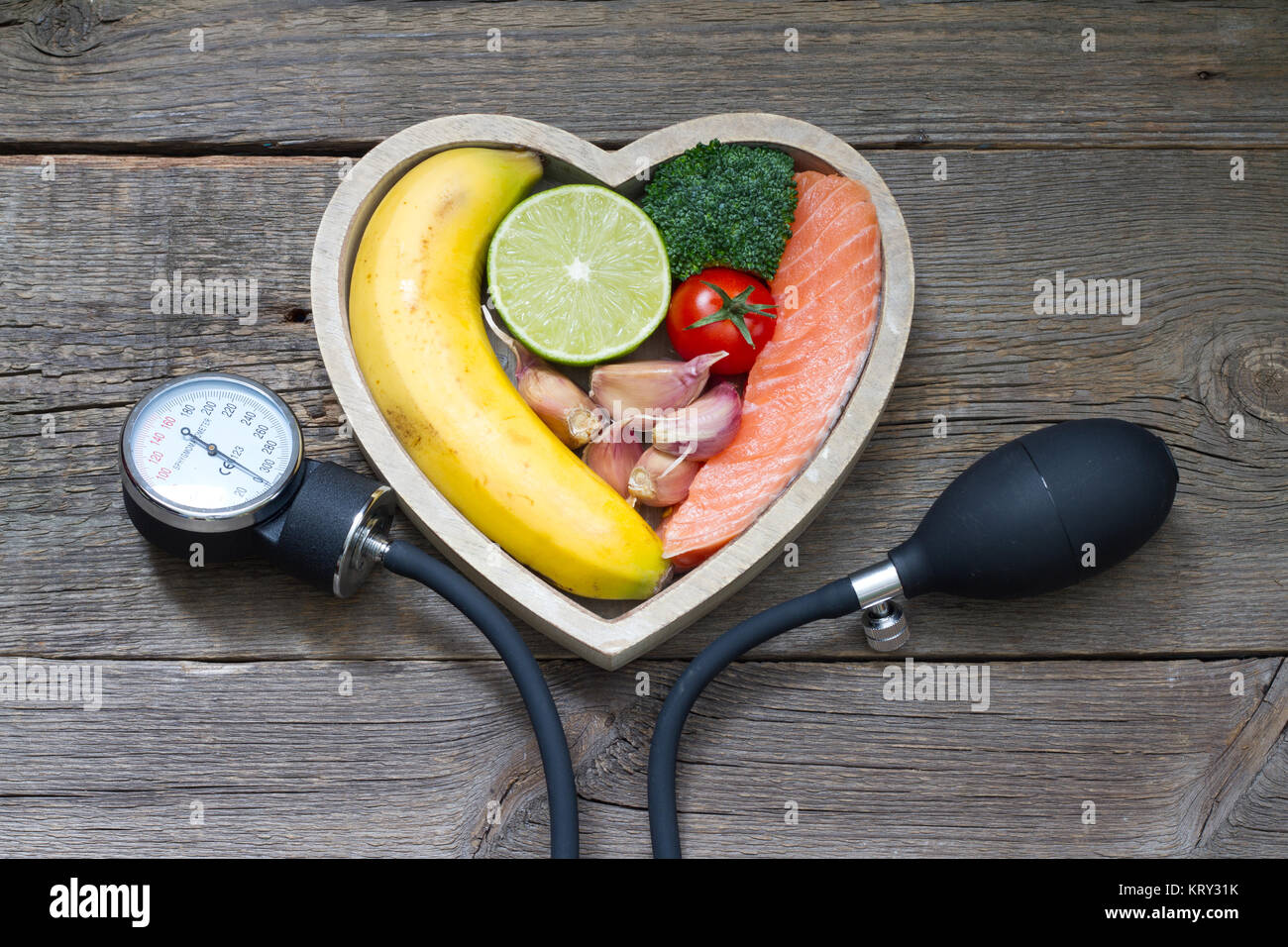 Health heart diet food concept with blood pressure gauge Stock Photo
