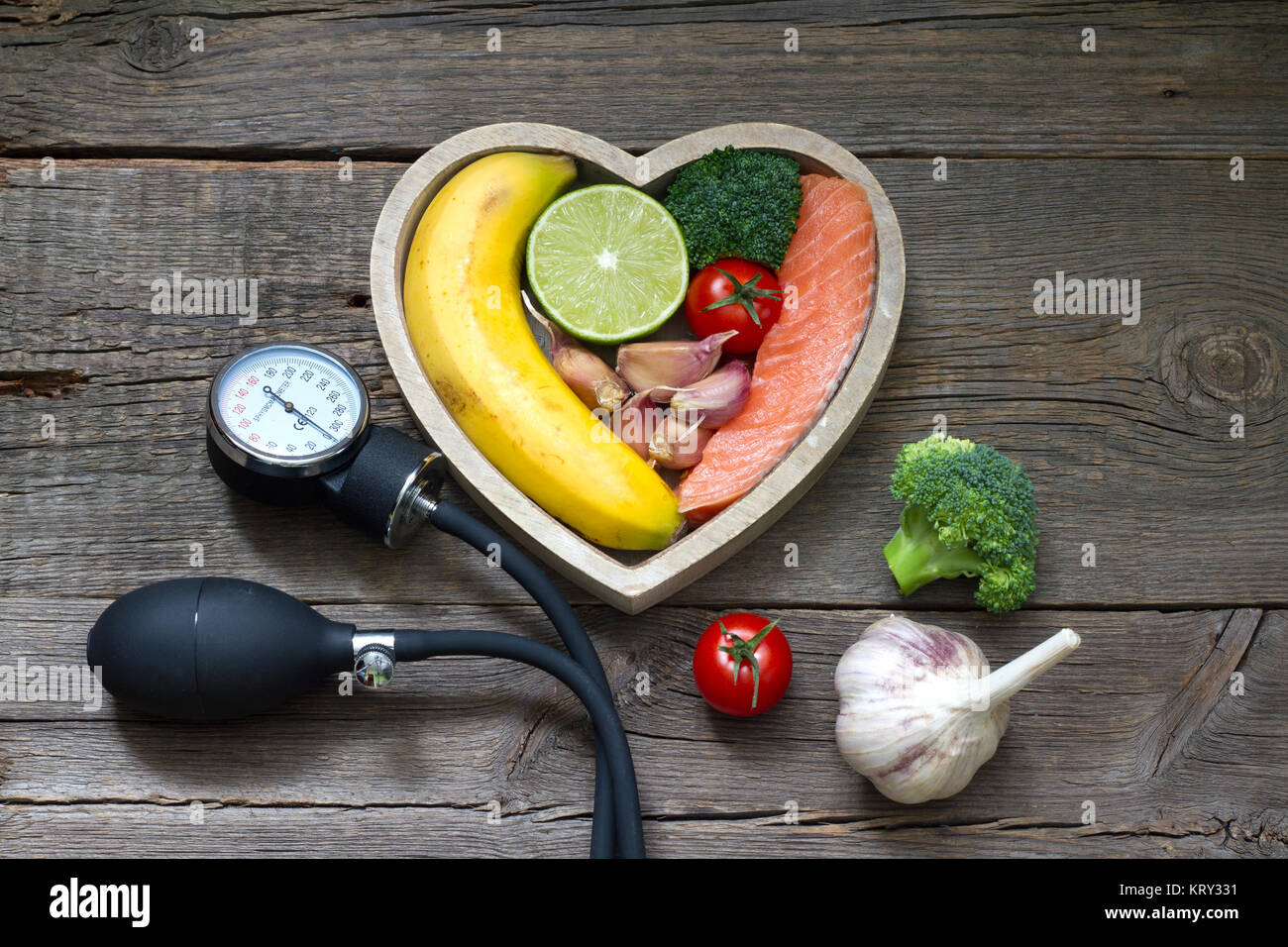 Health heart diet food concept with blood pressure gauge Stock Photo