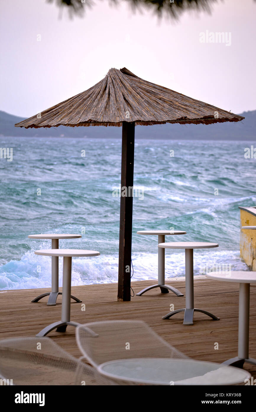 Beach bar parasol by rough sea Stock Photo Alamy