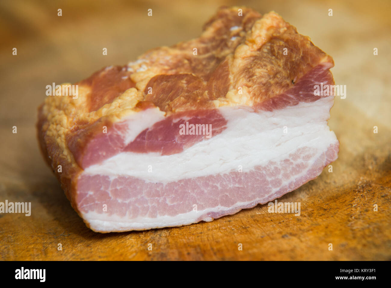 close up on smoked bacon on wood background Stock Photo