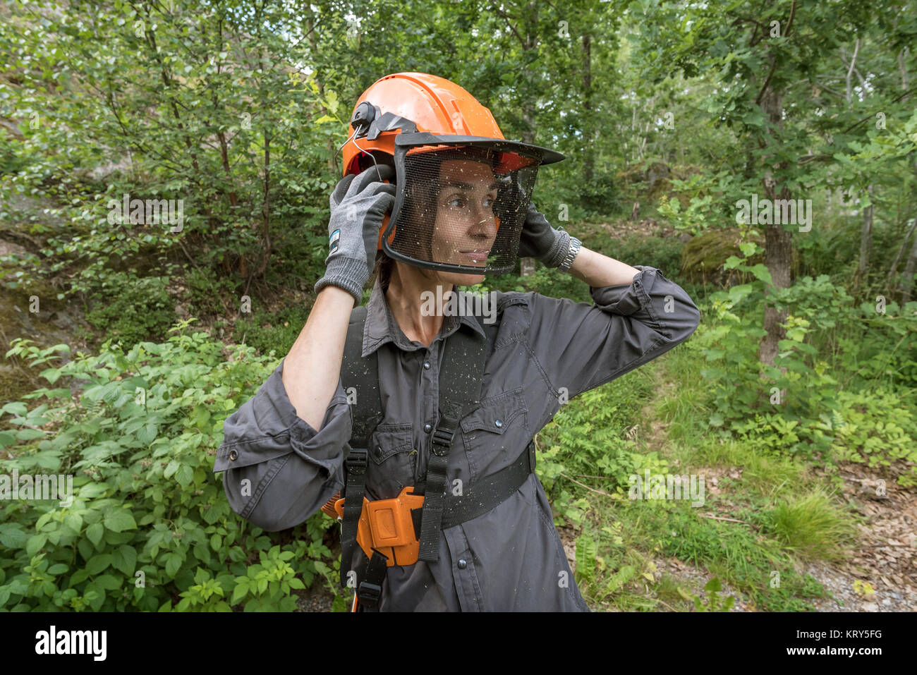 A woman wearing safety gear Stock Photo