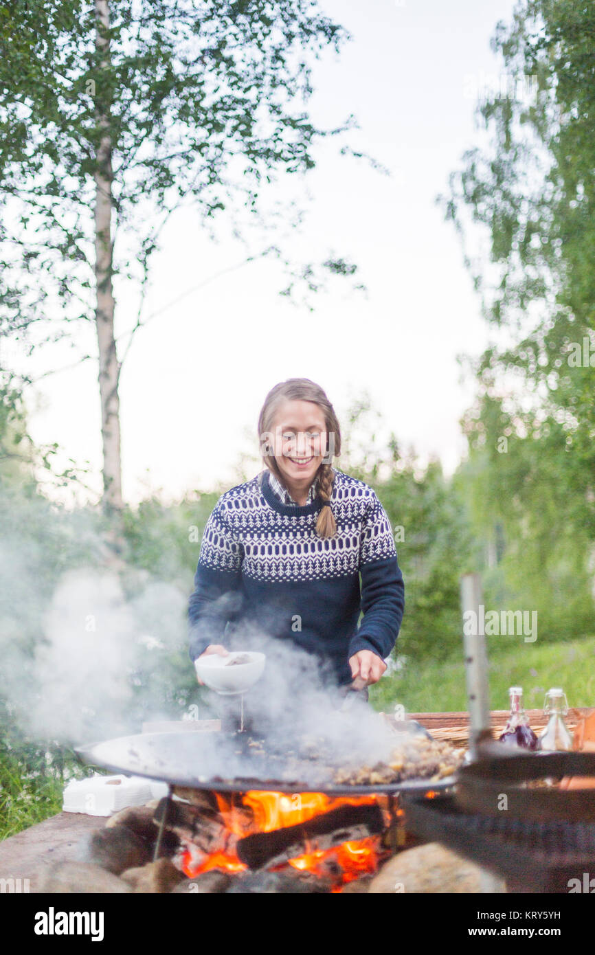 A woman cooking on a fire pit Stock Photo