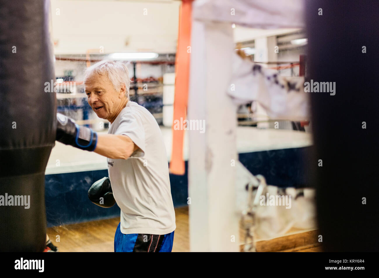 Senior man training with a punching bag Stock Photo Alamy