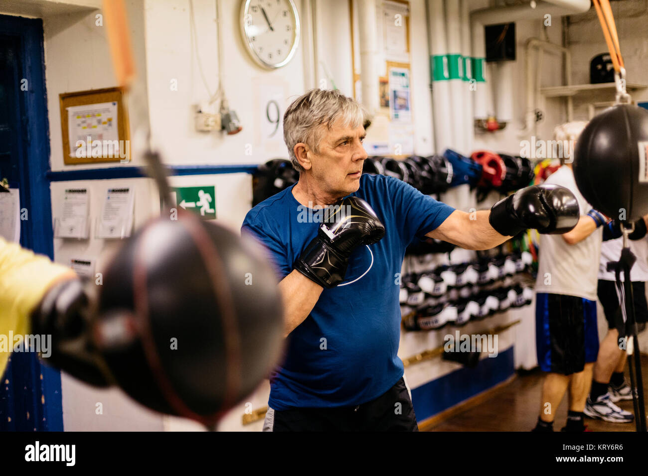 Senior man training with a punching bag Stock Photo Alamy