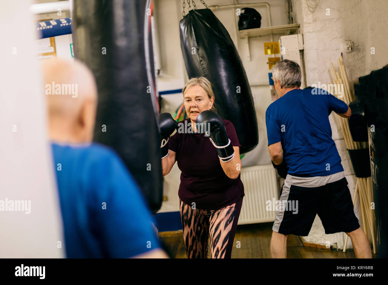 Senior woman training with a punching bag Stock Photo Alamy