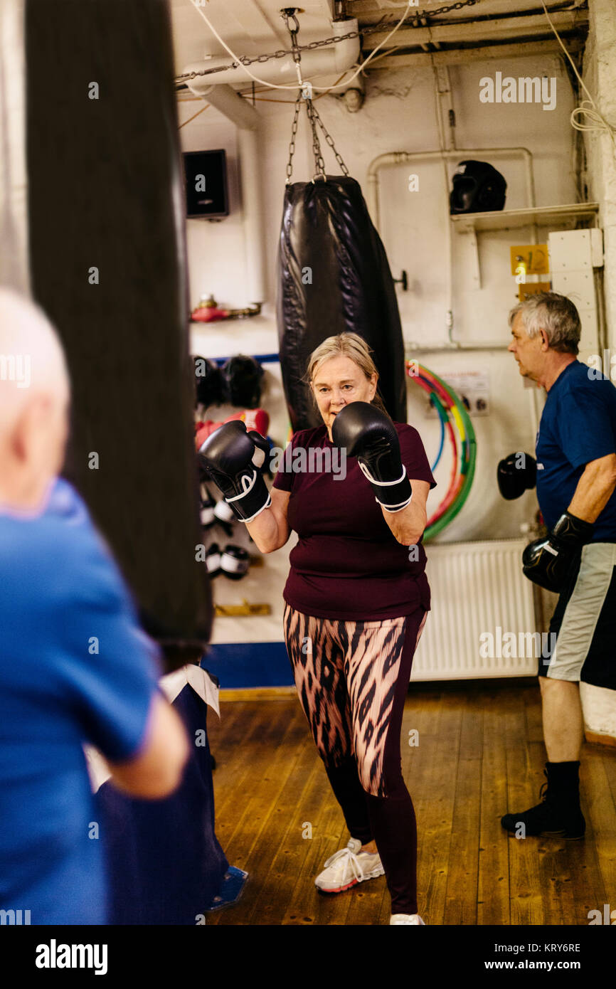 Senior woman training with a punching bag Stock Photo Alamy