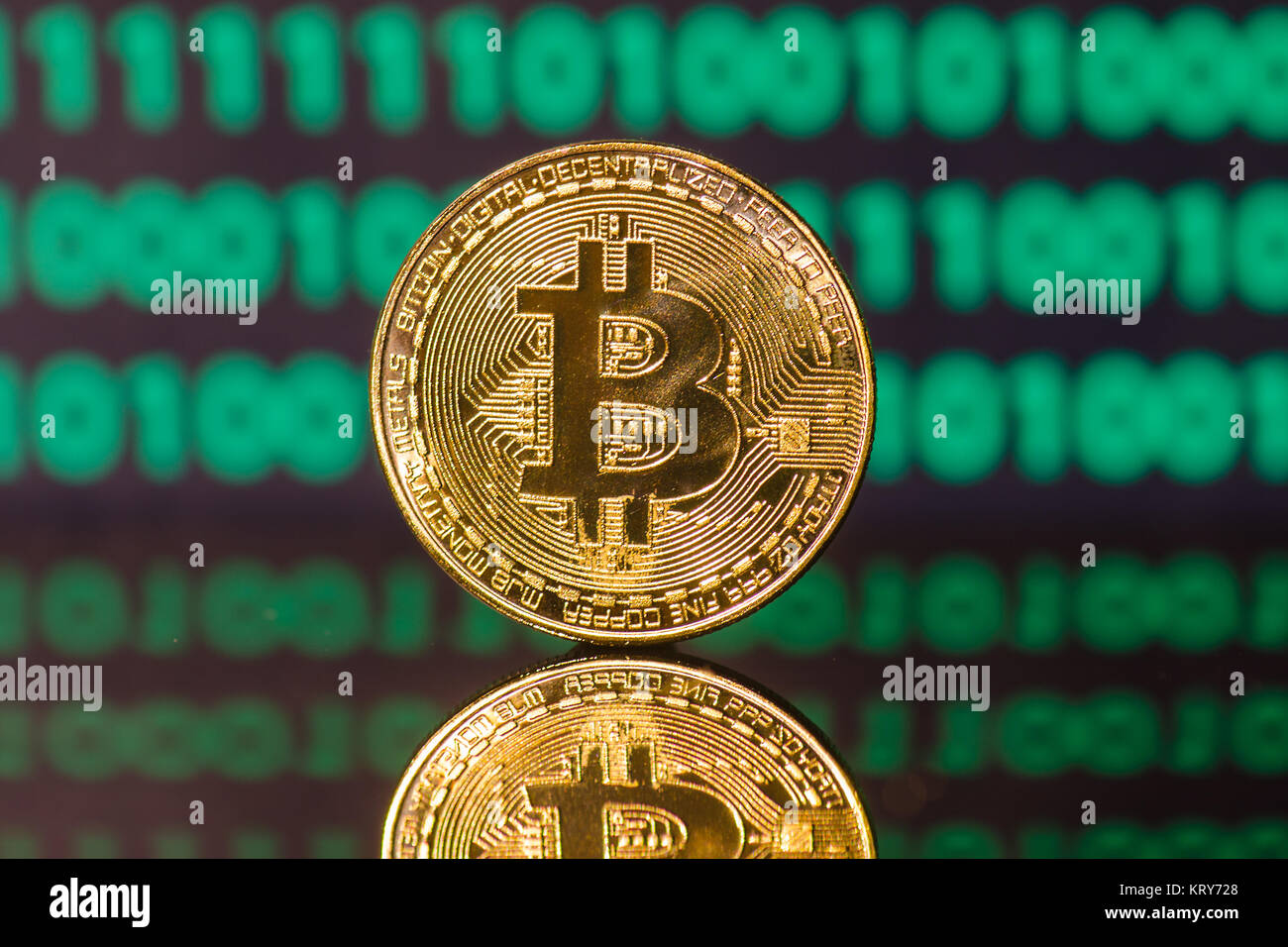 bitcoin symbol in front of a green binary code on a acrylic mirror Stock  Photo - Alamy