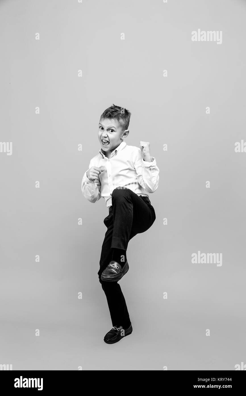 Happy schoolboy jumping for joy. Happiness, activity and child concept. Stock Photo