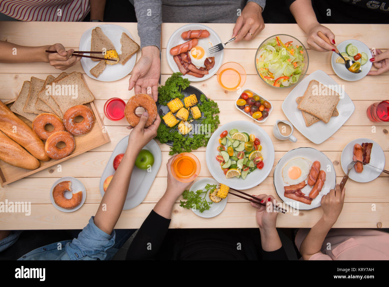 Enjoying dinner with friends. Top view of group of people having dinner