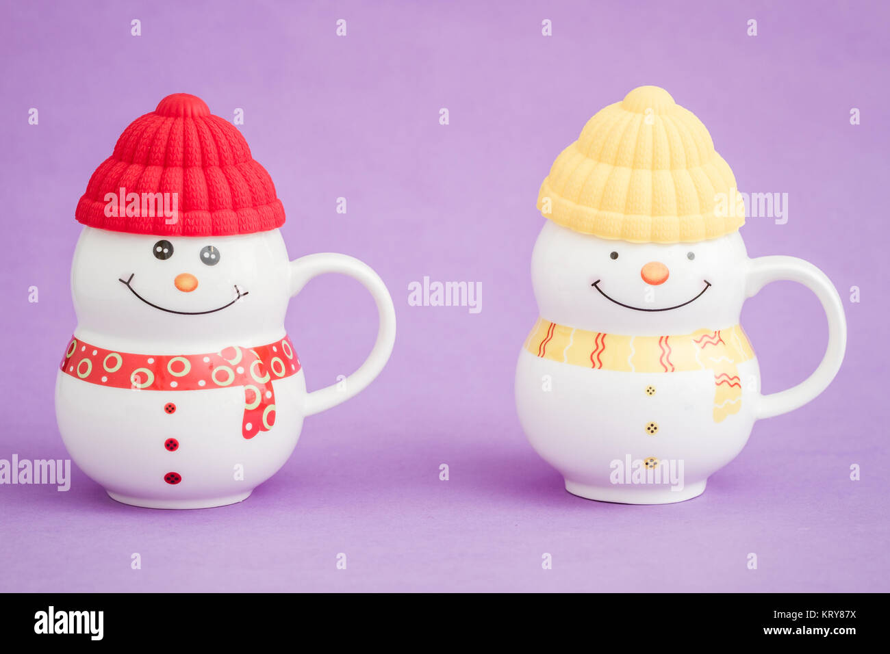 Colorful Porcelain Mug as Snowman on purple background Stock Photo