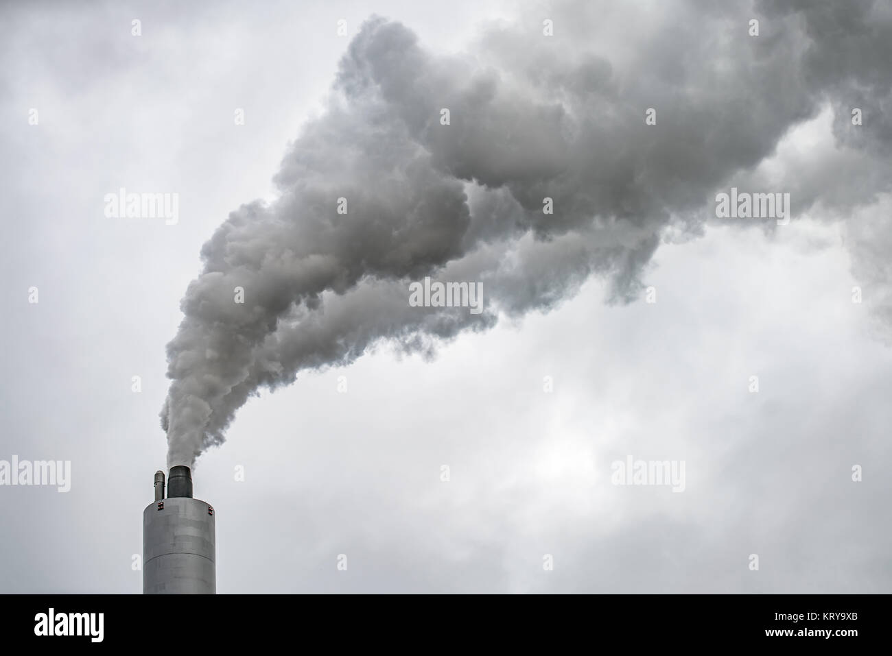 Smoking chimney of power plant Stock Photo