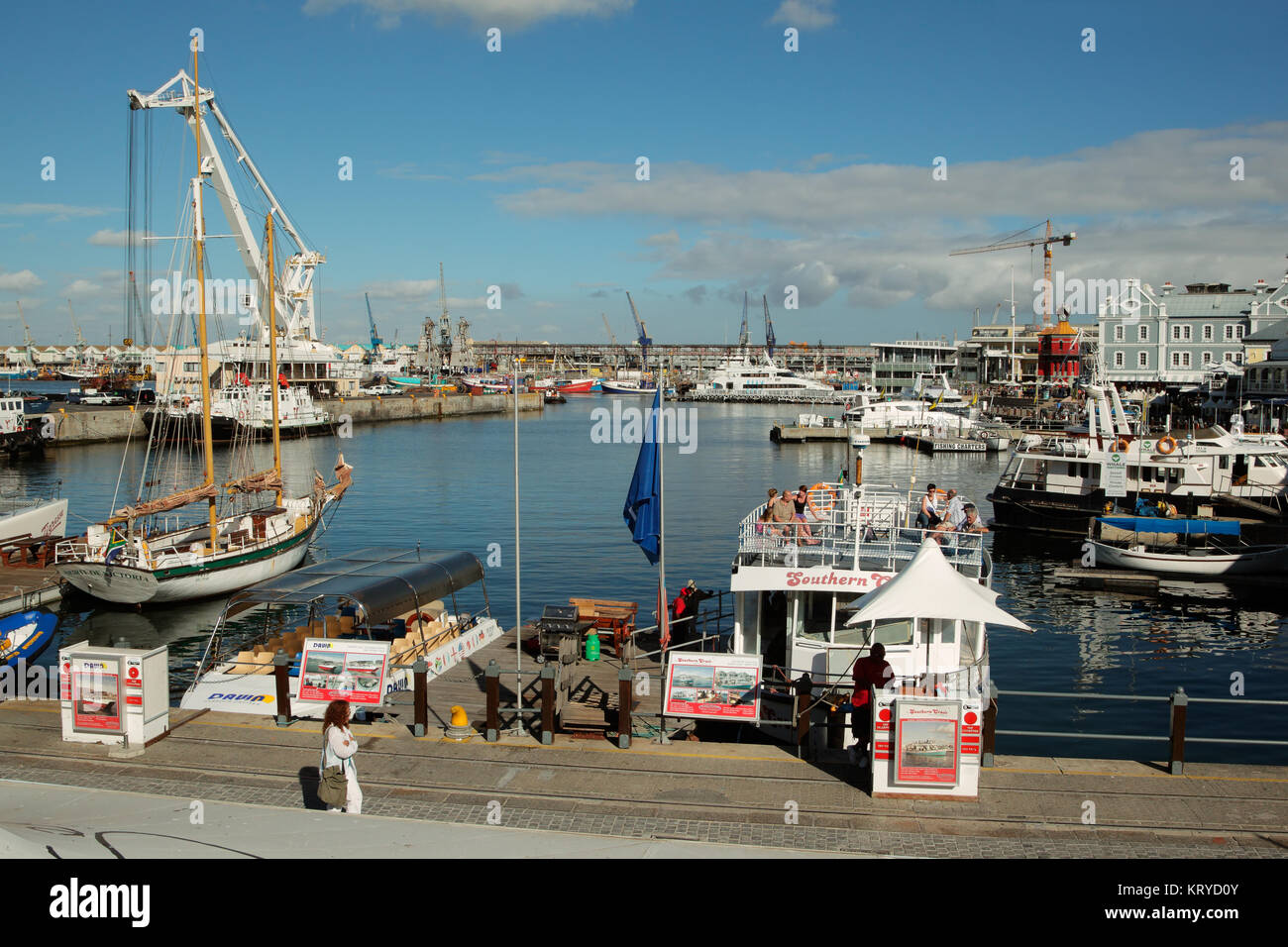CAPE TOWN, SOUTH AFRICA - FEBRUARY 20, 2012: Victoria and Alfred Waterfront, harbor with boats, shops and restaurants popular with tourists. Stock Photo