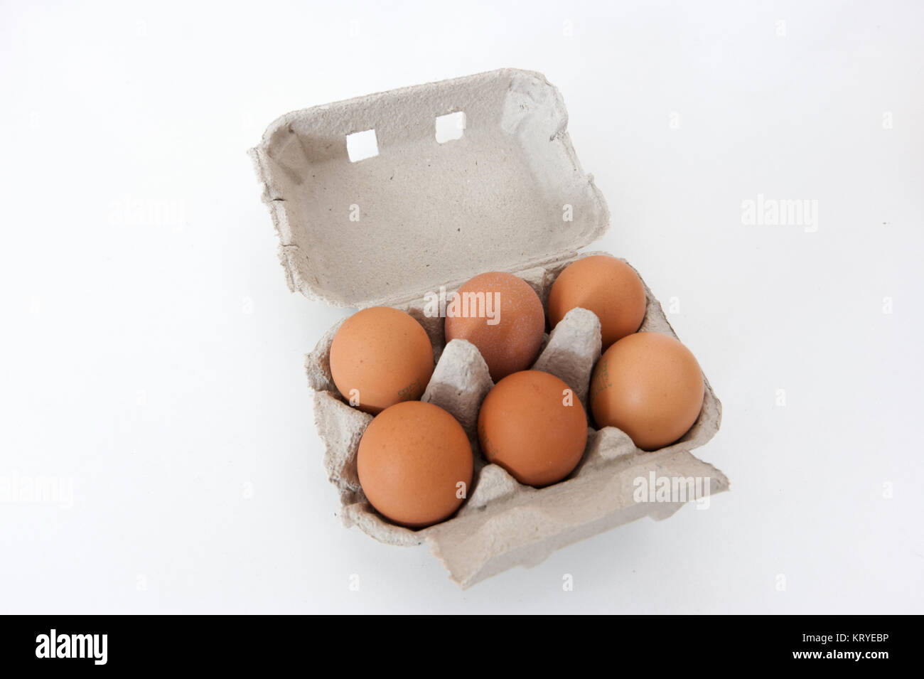 Box of six fresh organic brown chicken eggs in an open recyclable paperboard - moulded pulp - carton, white background Stock Photo