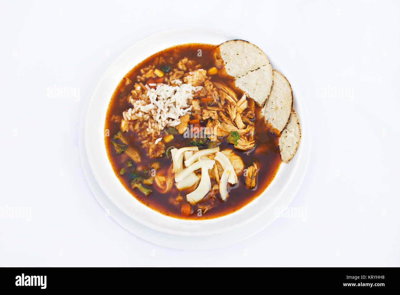 Caldo tlalpeno is a Mexican savory chicken vegetable soup flavored with smoky chipotle chiles, avocado and lime. It is enriched with sauteed rice and  Stock Photo