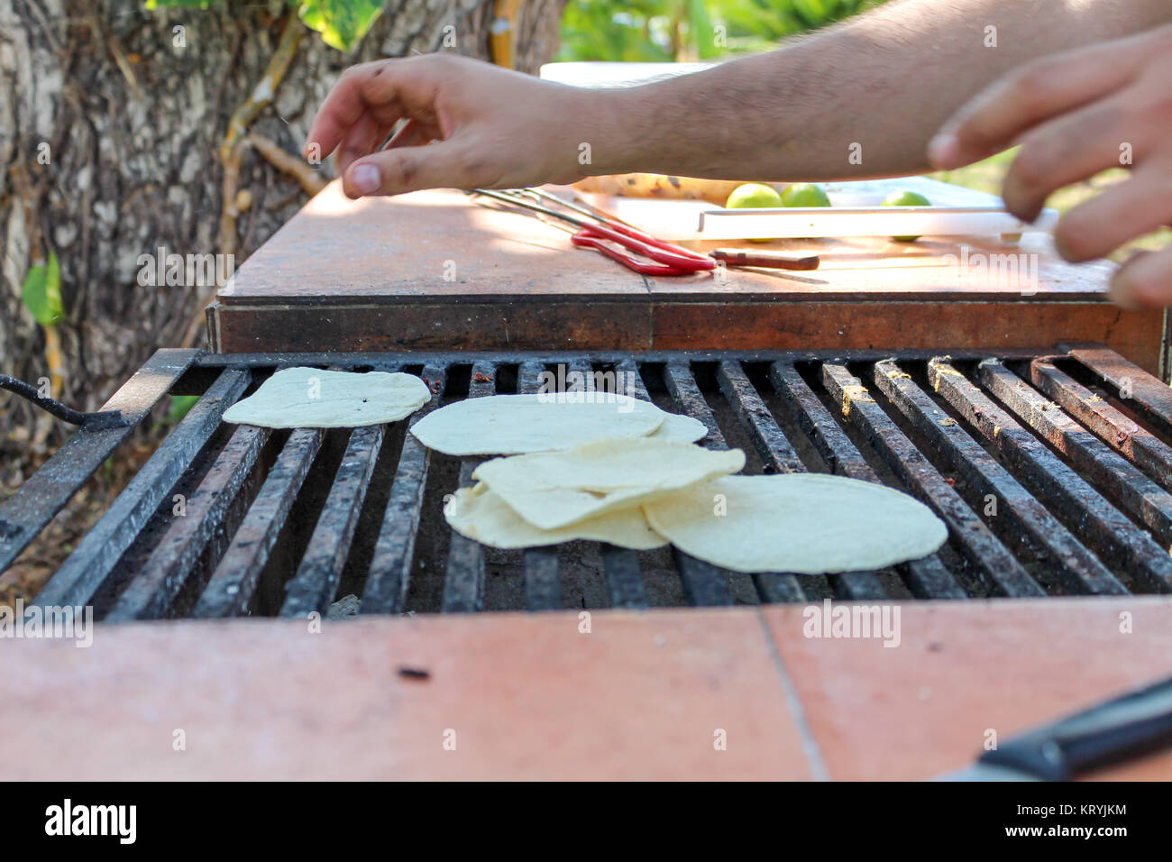 Man cooking Tortillas on a wood burning oven Stock Photo Alamy