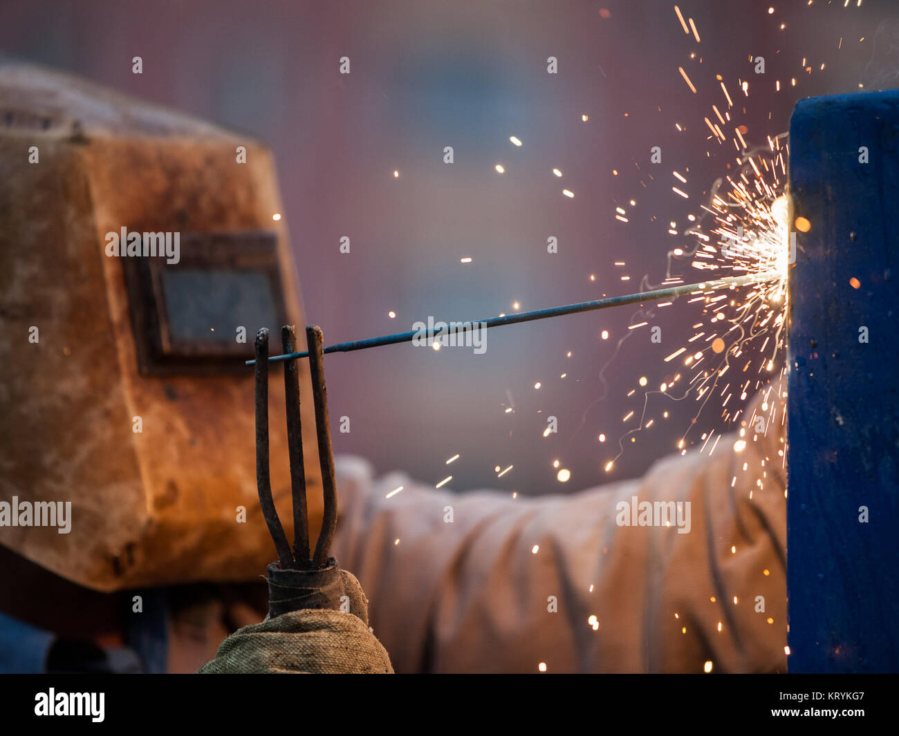 Heavy industry welder worker in protective mask hand holding arc