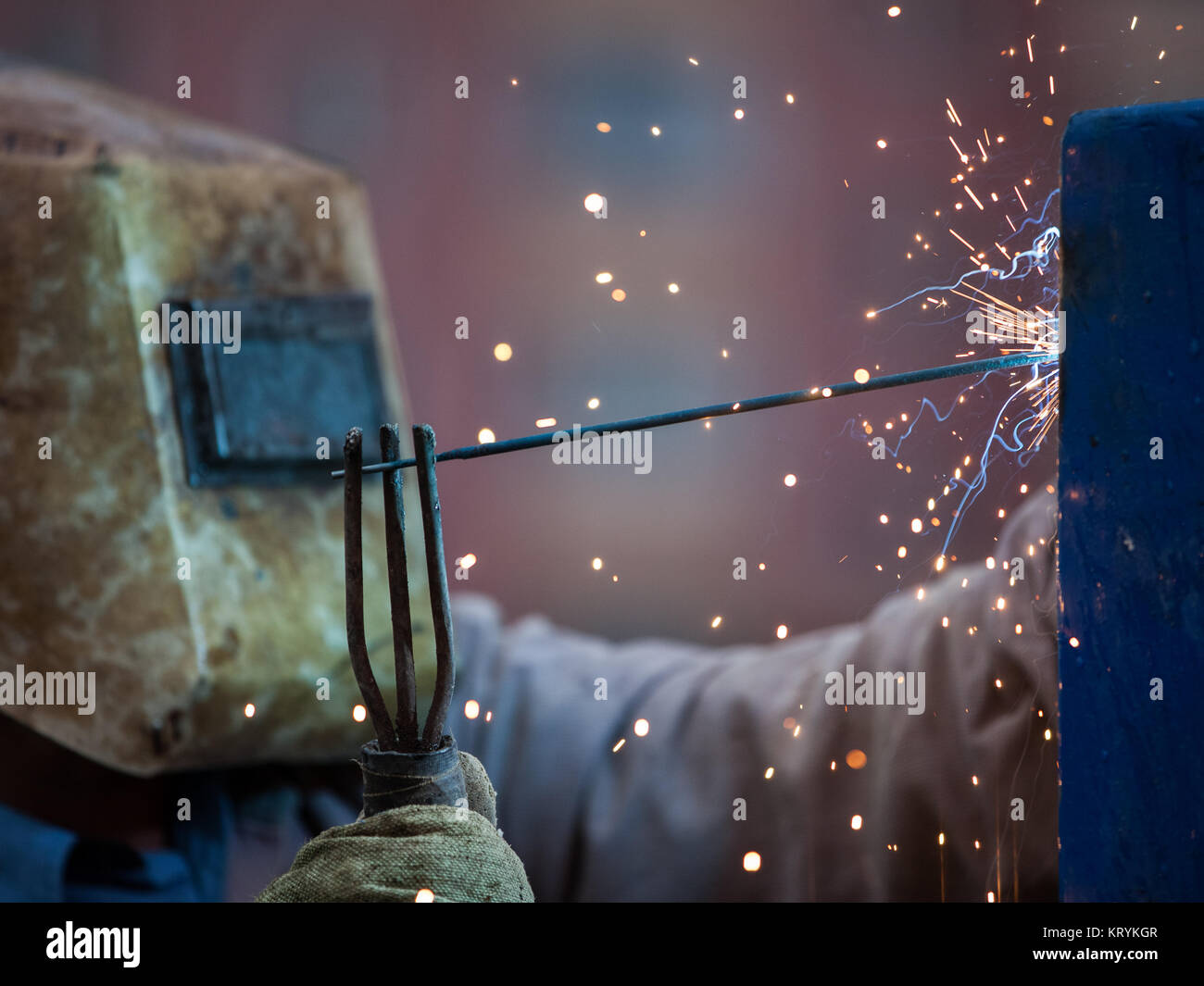 Heavy industry welder worker in protective mask hand holding arc