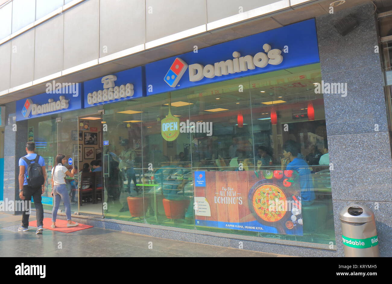 People visit Dominos Pizza fast food restaurant in New Delhi India. Stock Photo