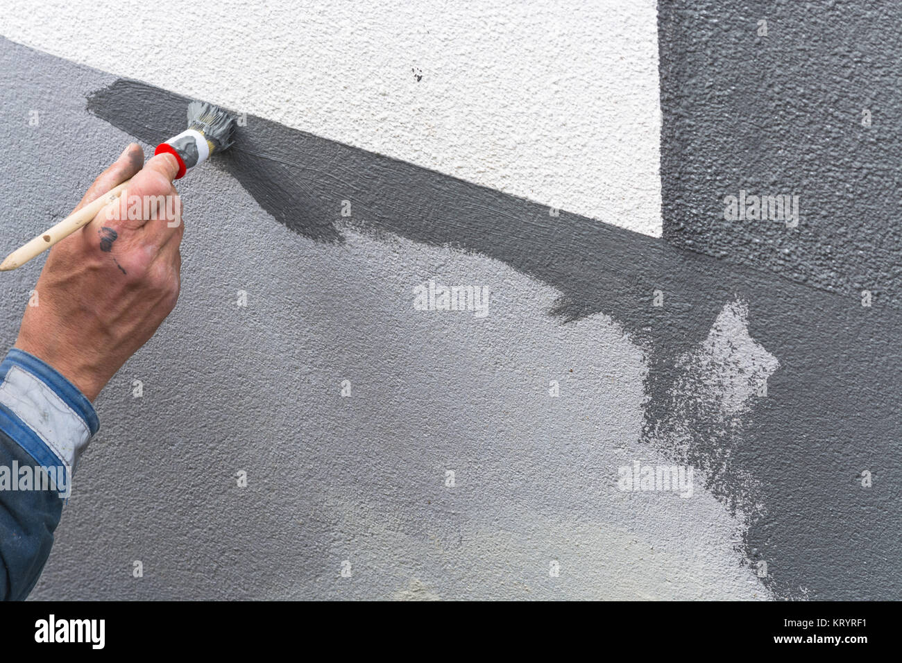 painter with paint roller in hand Stock Photo