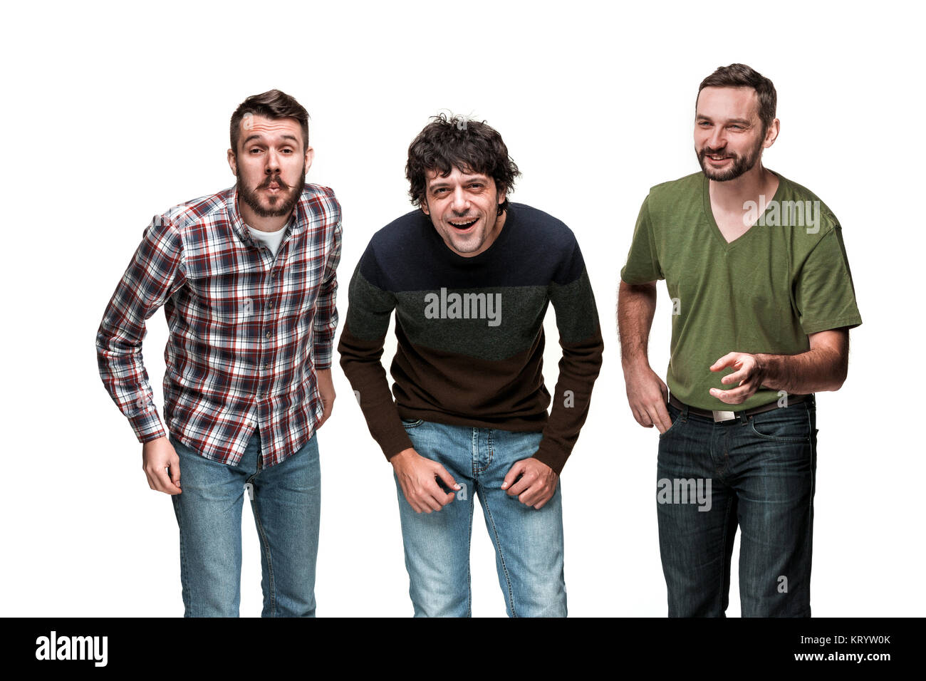 The three men are smiling, looking at camera Stock Photo - Alamy