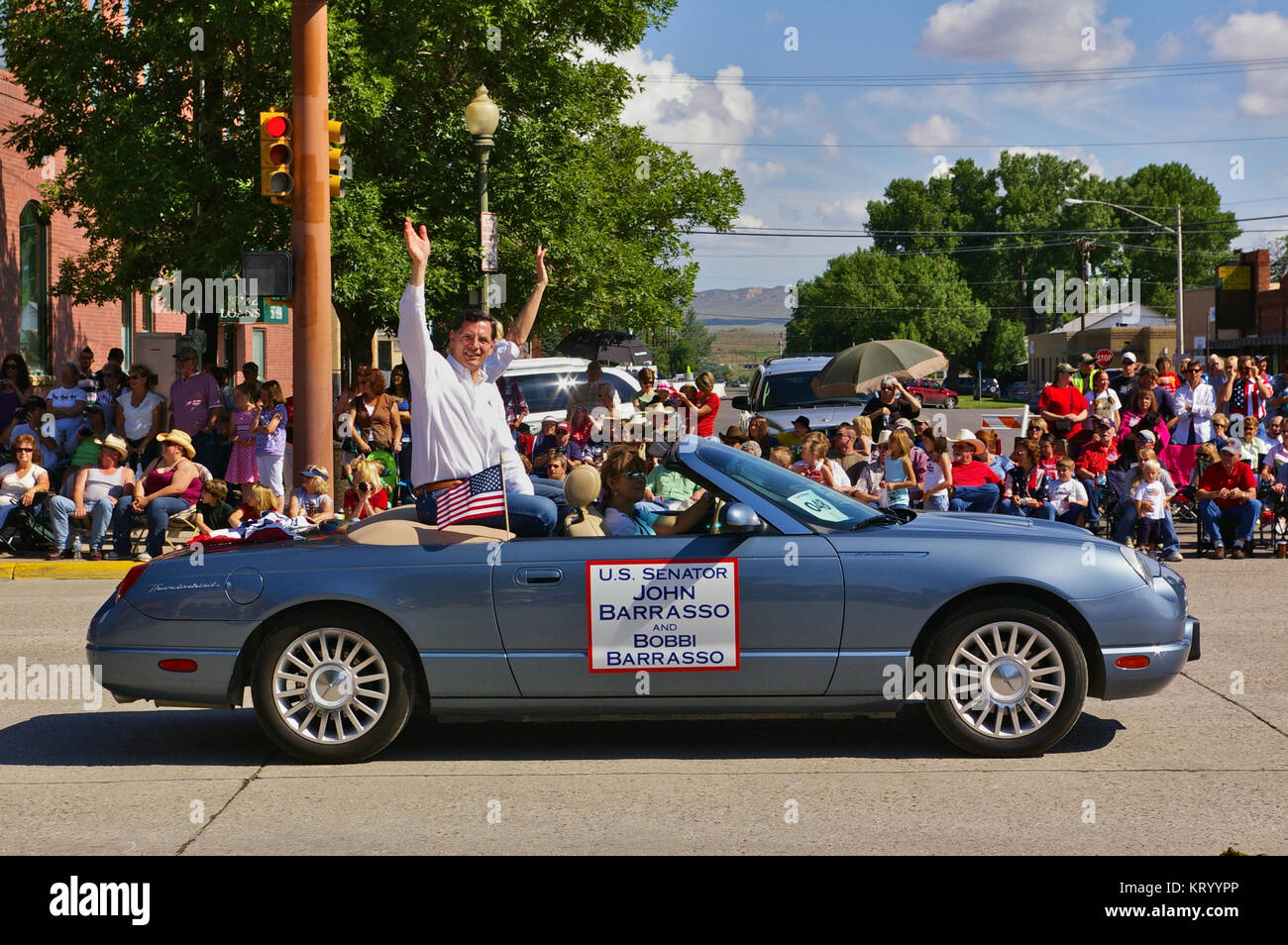 Cody, Wyoming, USA - July 4th, 2009 - U.S. Senator John Barrasso and his wife Bobbi riding in a convertible and waving while participating in the Inde Stock Photo