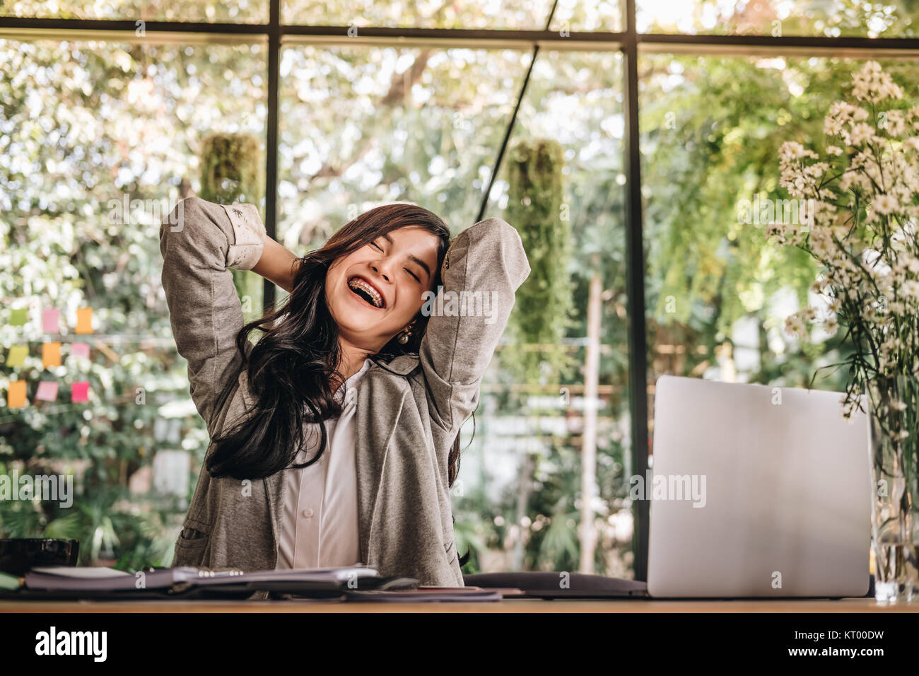 young start up woman put hand on head at office. freelance female entrepreneur glad with successful project. businesswoman working at workplace. succe Stock Photo